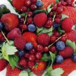 A variety of red fruits in a pile.