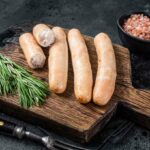 Turkey sausages on a wooden board.