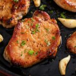 A grilled pork loin in a cast iron pan.