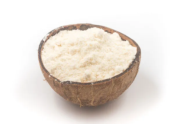 Coconut flour in a half-coconut shell.