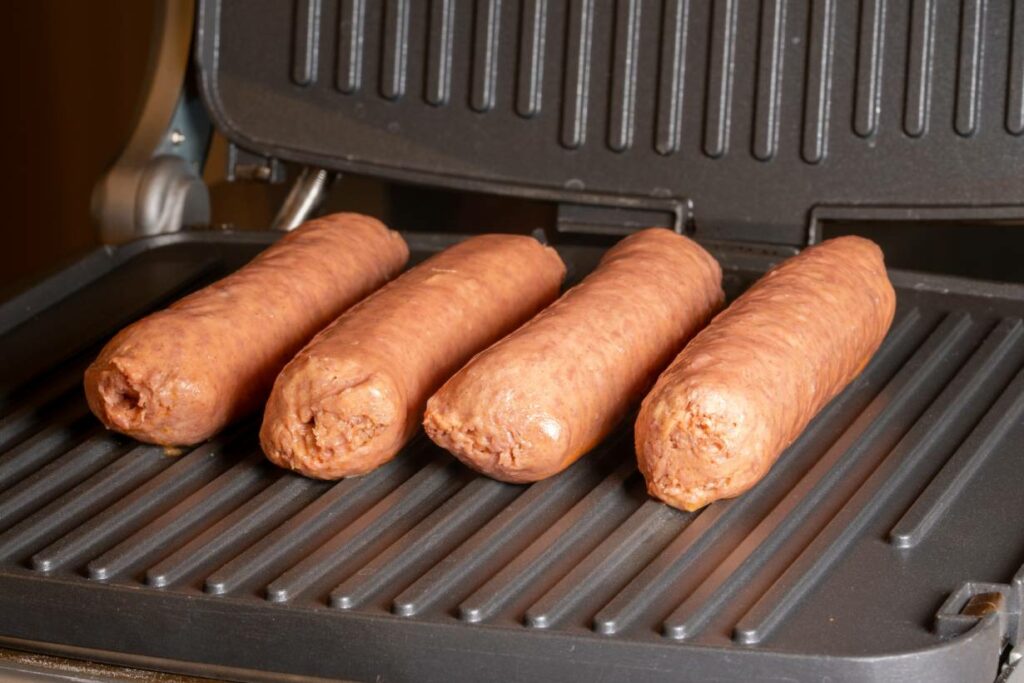 Four Beyond Sausage Links On a Grill.