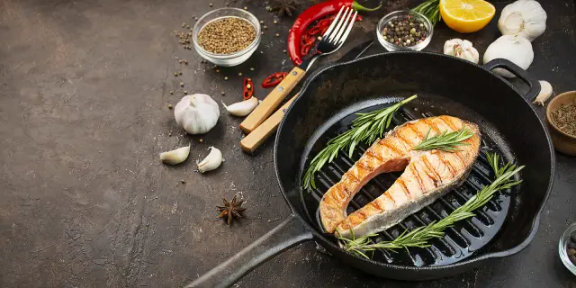 A grilled salmon fillet in a grill pan.