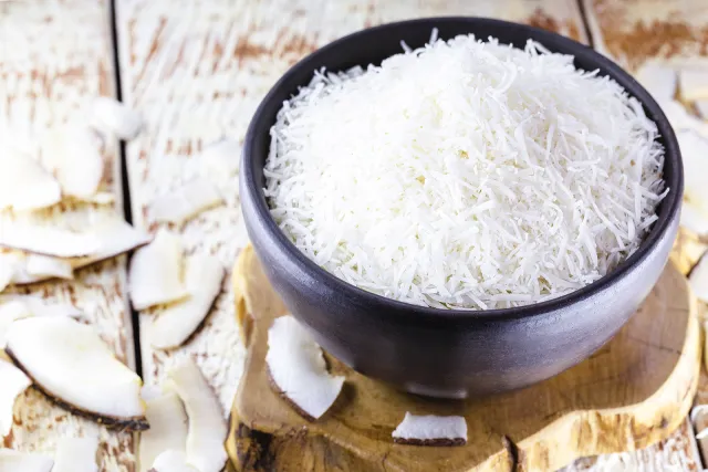 Shredded coconut in a clay bowl.