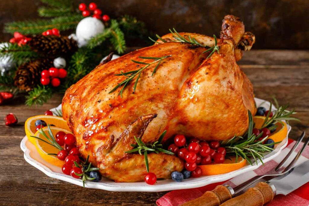 A roast turkey prepared for Christmas on a wooden surface..