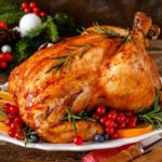 A roast turkey prepared for Christmas on a wooden surface..
