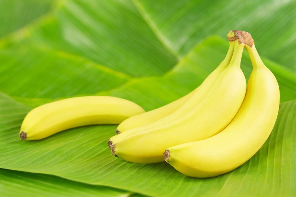 A bunch of bananas on a banana leaf.