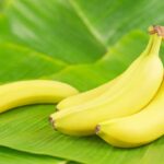 A bunch of bananas on a banana leaf.