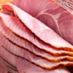 A joint of cooked ham that has been cut into slices.