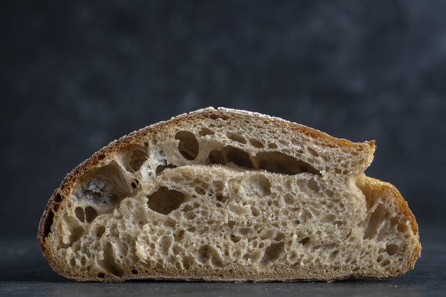 Image showing the natural air holes in a slice of sourdough bread.