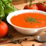 Tomato soup in a white bowl.