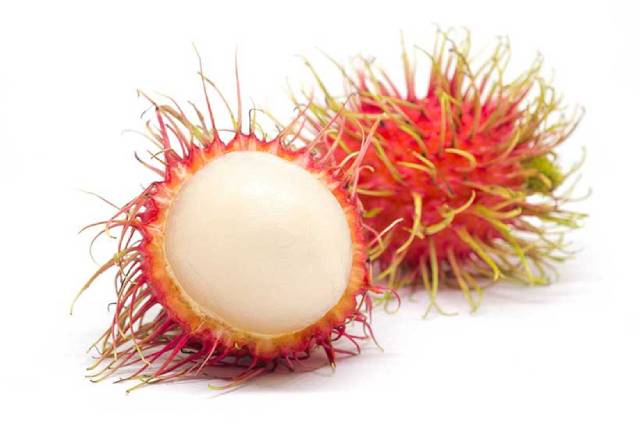 Whole rambutan next to half a rambutan.