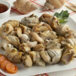 Cooked whelk on a plate.