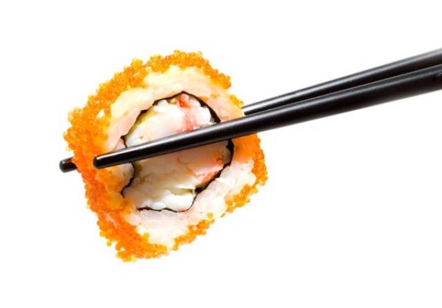 Chopsticks Holding a California Sushi Roll.