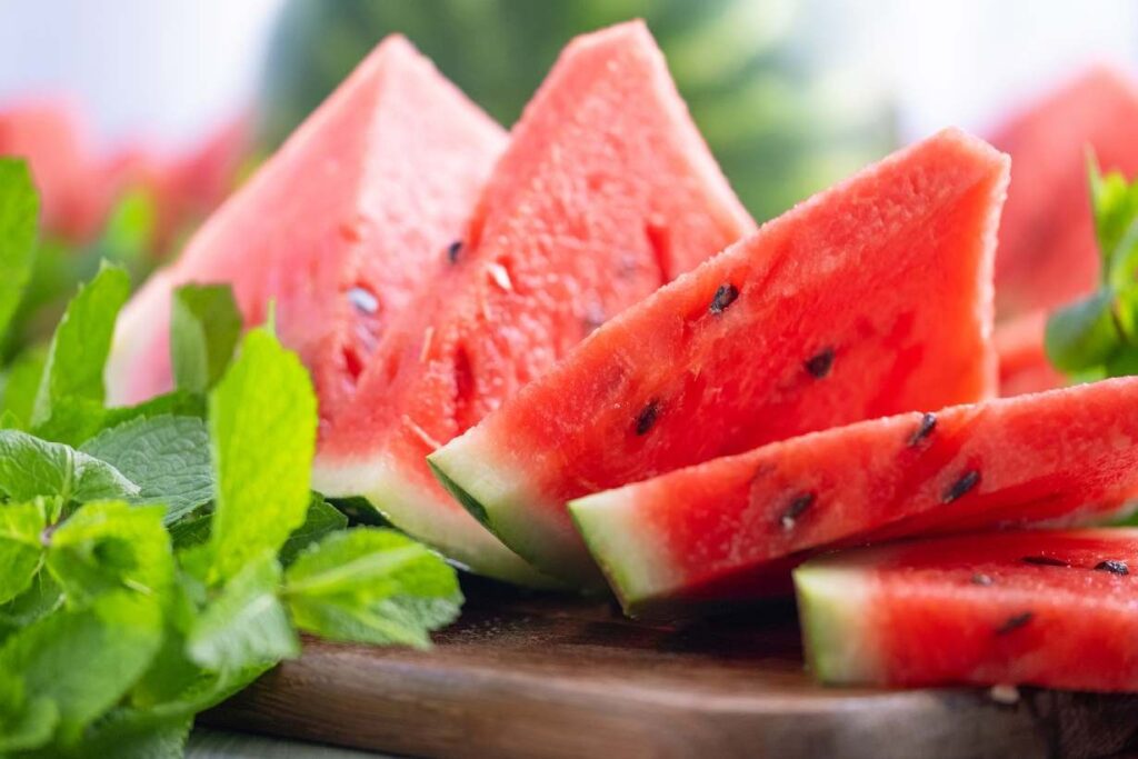 Several wedge slices of watermelon showing the inner red flesh and seeds.