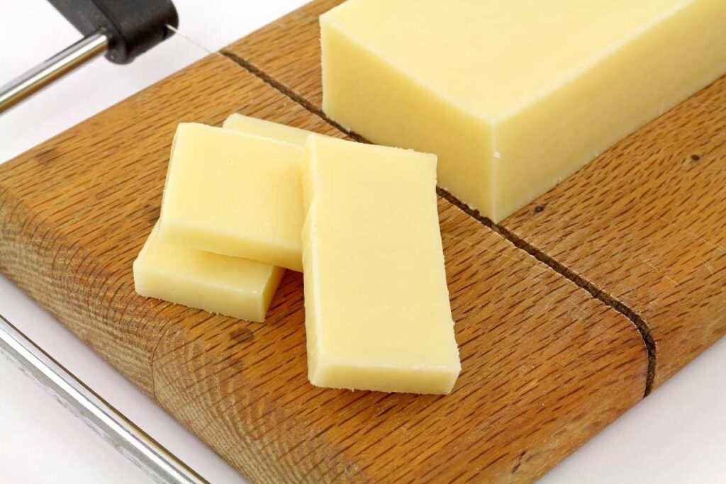 Fat-free cheese on a wooden chopping board.