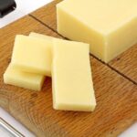 Fat-free cheese on a wooden chopping board.