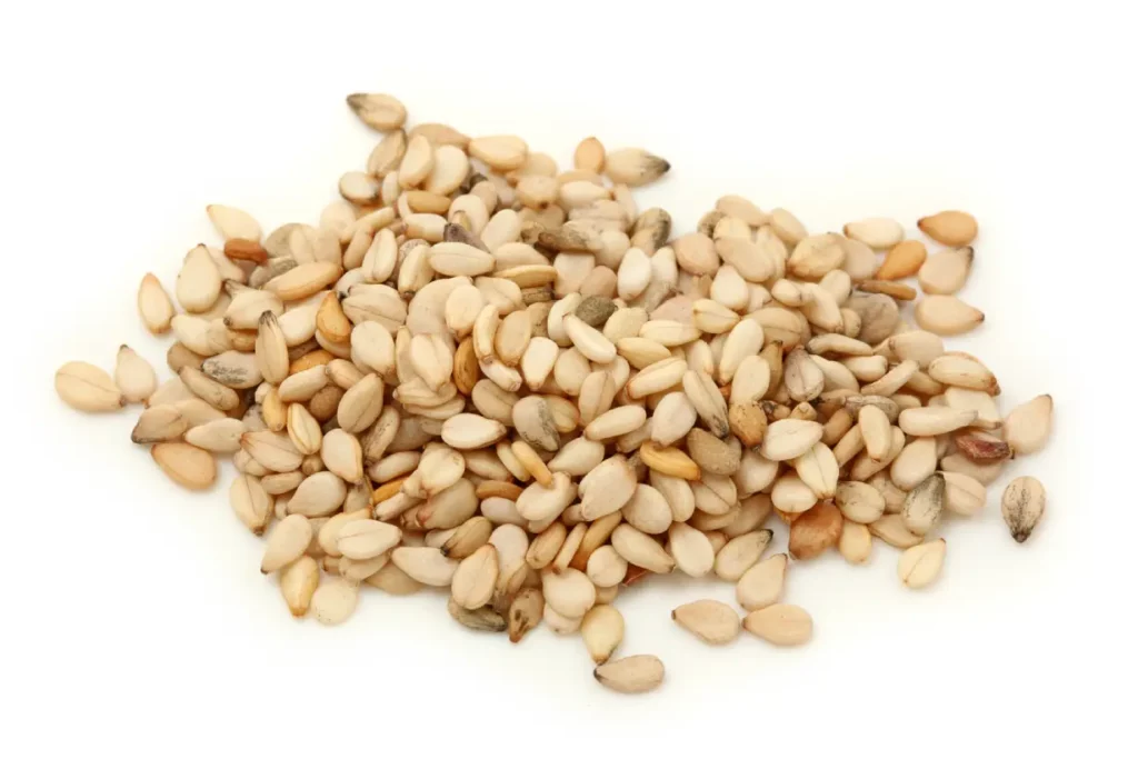 A handful of sesame seeds on a white background.