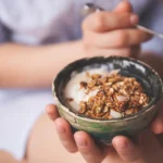 person-eating-healthy-bowl-of-breakfast-cereal
