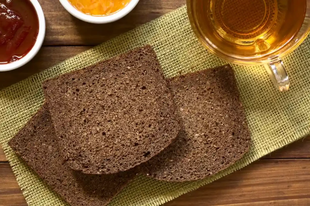 Three slices of traditional German pumpernickel bread.