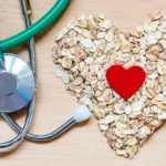 Oats arranged in a heart shape next to a stethoscope.