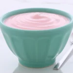 A serving of protein yogurt in a green bowl.