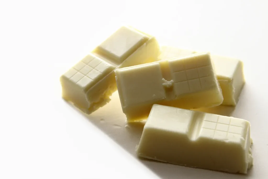 Pieces of white chocolate on a white background.