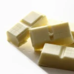 Pieces of white chocolate on a white background.