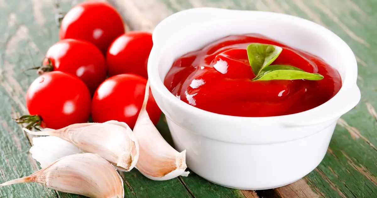 Tomato ketchup in a small white bowl.