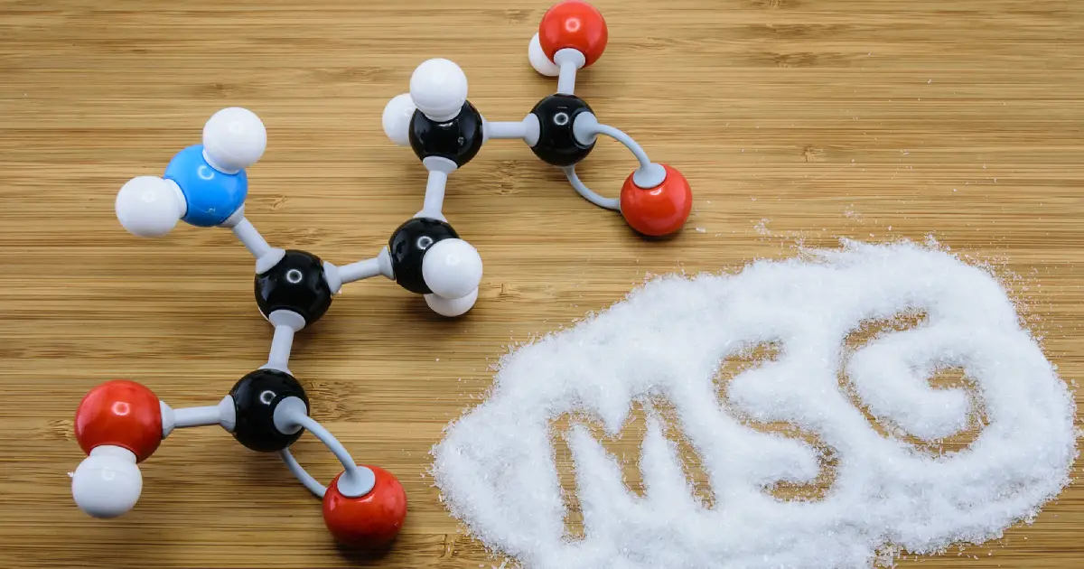 Monosodium glutamate (MSG) powder next to its chemical structure.