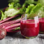 Beet Juice: Does It Really Have Health Benefits? A glass of beet juice next to several whole beets.