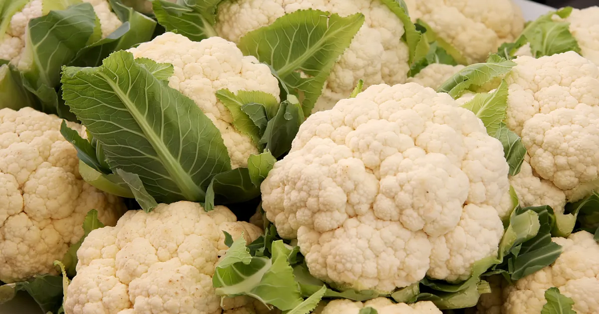 Several whole cauliflowers grouped together.