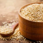 Quinoa: Potential Benefits and Full Nutritional Profile A wooden bowl of quinoa grains.