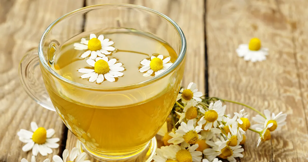 A glass cup of chamomile tea.